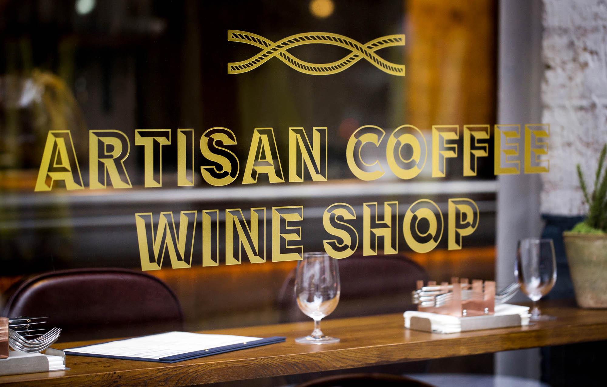 Gold lettering on the Comptoir window: artisan coffee, wine shop